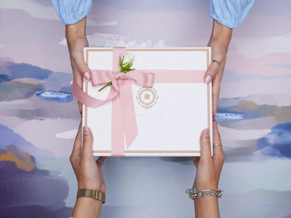 Two people exchanging a beautifully wrapped gift box, the art of thoughtful and intentional gift giving