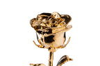 Macro close up of 24K gold dipped rose bloom showing reflective gold petal texture