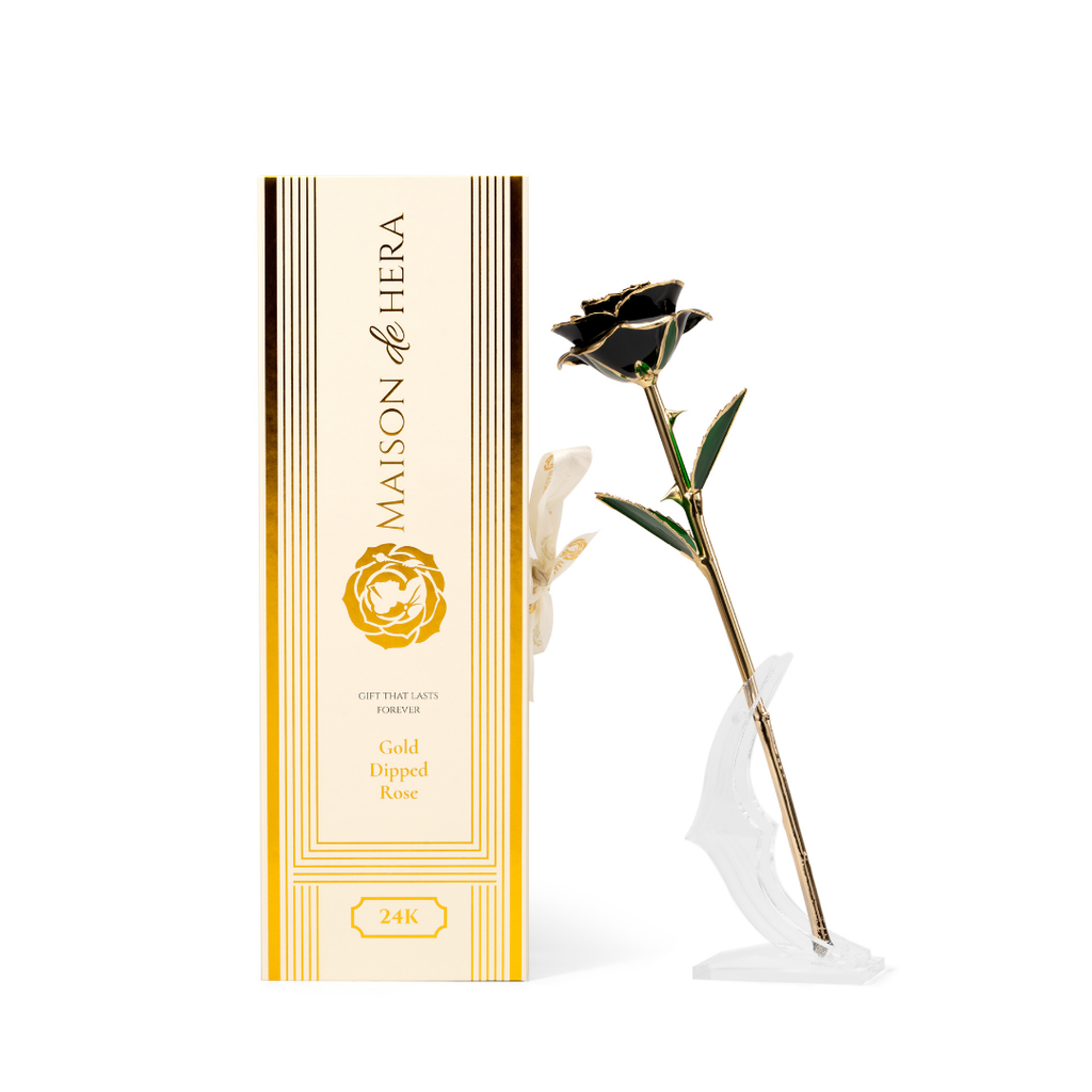Maison de Hera Blanc box next to 24K gold dipped black rose with green enamel leaves
