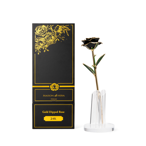 Maison de Hera Maison box next to 24K gold dipped black rose with green enamel leaves