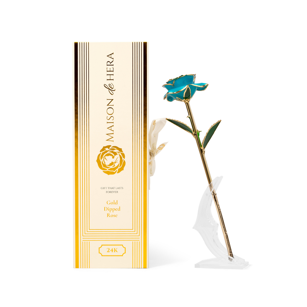 Maison de Hera Blanc box next to 24K gold dipped blue rose with green enamel leaves