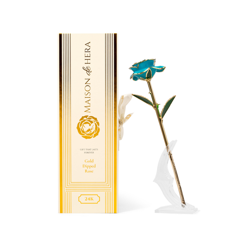 Maison de Hera Blanc box next to 24K gold dipped blue rose with green enamel leaves