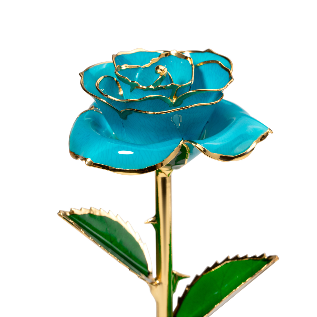 Close up of 24K gold dipped blue rose with blue enamel petals and gold trim
