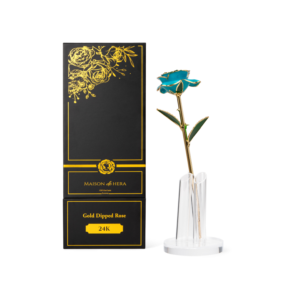 Maison de Hera Maison box next to 24K gold dipped blue rose with green enamel leaves