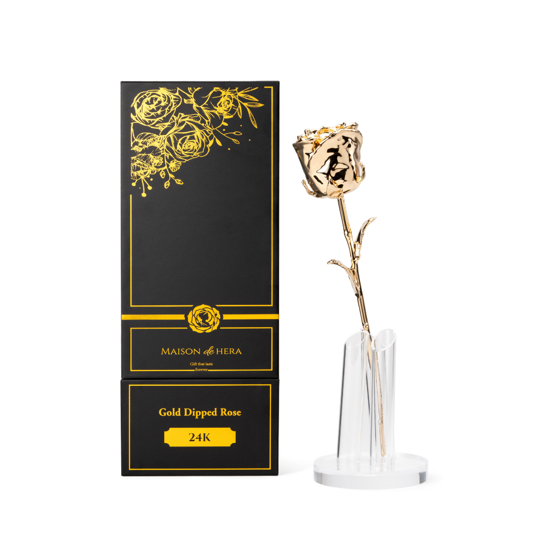 Maison de Hera black Maison Edition box next to 24K gold dipped rose on clear display stand