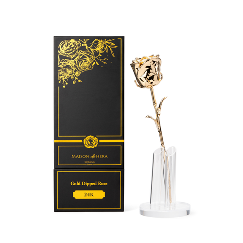 Maison de Hera black Maison Edition box next to 24K gold dipped rose on clear display stand